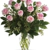 Dozen pink roses in a glass vase