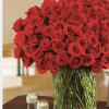 Beautiful 100 roses designed in oversized cylinder vase. 