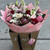 This is a modern wrapped bouquet with pink and red roses including