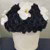This luxurious arrangement showcases striking black roses paired with delicate white orchids
