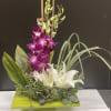 This Beautiful arrangement made with purple dendrobium orchid, white lily , bamboo