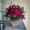 Enjoy the vibrant beauty of red and classic white roses, complemented by