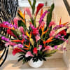 Selective Tropical Flowers arranged in a ceramic container. Approx. 30 inches tall