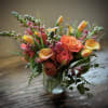 Cheerful sunny colors gathered in a unique glass vase to brighten any