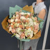 This delightful bouquet showcases peach roses, white hydrangeas, spray roses, and pink