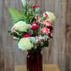 A sweet bouquet of white roses, colorful mini carnations, and more in