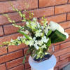 Simply gorgeous, artistically arranged bouquet of dendrobium orchids and tulips cozied up