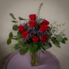 A beautiful arrangement of roses and other fillers.  Color can be