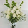 Modern Dozen long stem roses. White and green arrangement in a clear