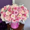 This vibrant floral arrangement is a lush combination of soft pink roses