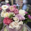 Lovely Mixture of sweet pink flowers in hat box.