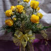 One dozen yellow roses arranged with babies breathe and greenery in a
