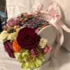 A small purse, embellished with assorted colored buttons, the word Mom and