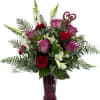A romantic arrangement in red, white and lavender flowers such as roses