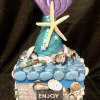 This bloom box is adorned with real seashells, wonderful mom sayings, a