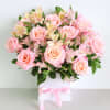 Arrangement in a box with pink Roses and Alstroemeria.