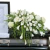 Elegant white premium flowers in a lush casket spray.