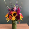 Fresh and beautiful vibrant arrangement filled with a variety of flowers, lilies