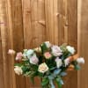 An arrangement of blush pink and white tones, contains lisianthus, roses, dahlias