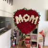 Honor a beloved mother with this stunning heart-shaped floral tribute, designed to