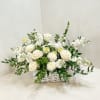 Assorted flowers arranged in a basket.