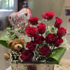 Cute arrangement of 12x roses, a teddy bear, and a valentines balloon