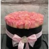 Beautiful pink roses arrange in a black hat box in all different