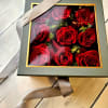Low lush roses nestled beautifully in a soft gray peak-a-boo box. Its