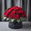 Two Dozen cute short stemmed red roses either in a vase or