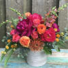 Seasonal blooms in vibrant colors gathered in a modern container for a