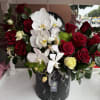 A sophisticated arrangement set on a sleek faux black marble base, featuring