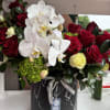 A sophisticated arrangement set on a sleek faux black marble base, featuring