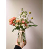 A jar style vase with seasonal blooms. Designer&#039;s Choice of Blooms: carefully