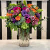A beautiful assortment of colorful flowers are complimented by succulents. 