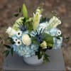 Wonderful whites and blues in a cube or cylinder vase. Assorted blooms