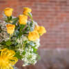 Beautiful and fragrant yellow roses arranged in a glass vase. Extra long