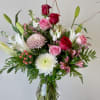 A pink, red, and white Valentine&#039;s Day floral arrangement typically features a