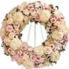 A 24&quot; wreath with a mix of soft blush and white flowers.