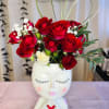 Beautiful container with a sweet face and fresh red roses for you.