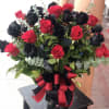 36 red and black roses, in a clear vase. Red and black