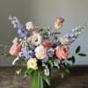 Capture the magic of a breathtaking sunset with this exquisite floral arrangement