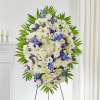 Pay your respects with a standing tribute of white and blue florals