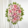 Artfully arranged pink and white florals create a captivating standing spray to