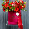 This is a luxurious floral arrangement in a velvet box of raspberry