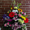 A gorgeous fresh floral arrangement with a variety of bright colored flowers.