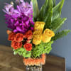 The pretty rustic colors in a glass vase with river rocks makes