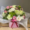 Sweetly sophisticated, this arrangement of green miniature hydrangea and light pink spray