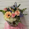 A mix of pastel flowers arranged beautifully in a bubble bowl with