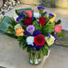 A bright and modern arrangement of roses, hydrangeas and other flowers with