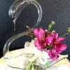 This delightful hand-blown glass vase with floral arrangement is the perfect touch